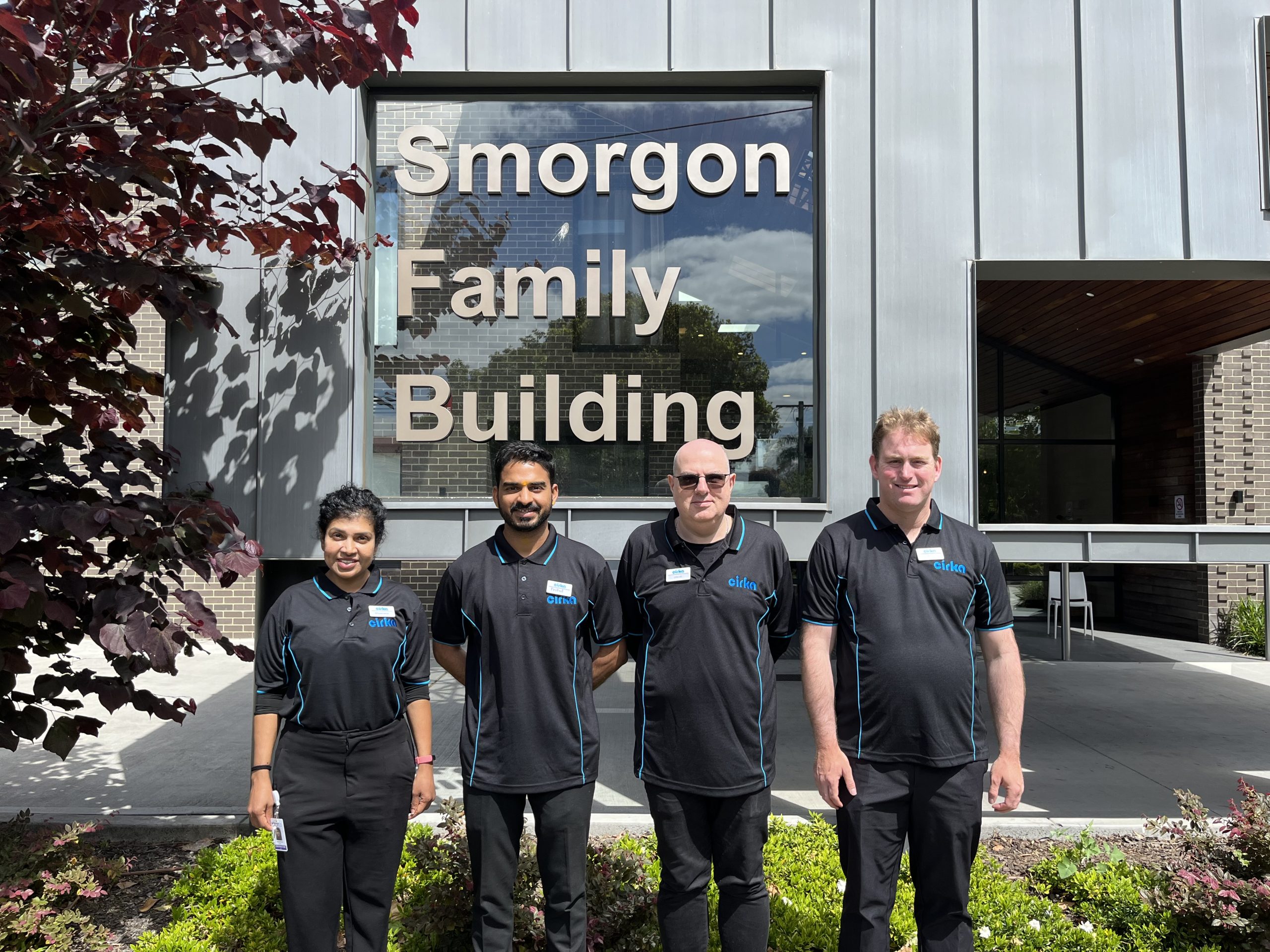 Cirka Staff in front of a JCV building