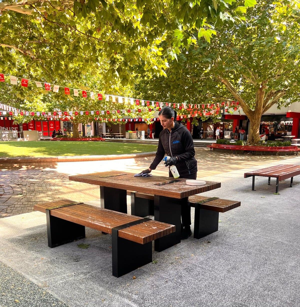 Cleaner wiping down tables at La Trobe University