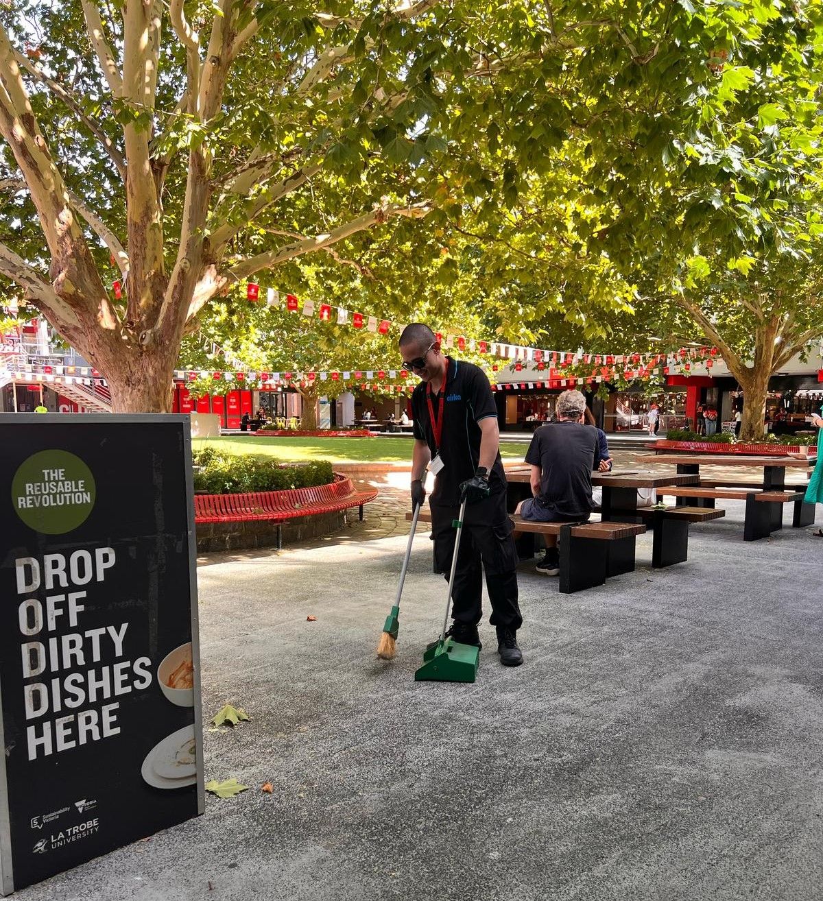 Cleaner sweeping floor at La Trobe University