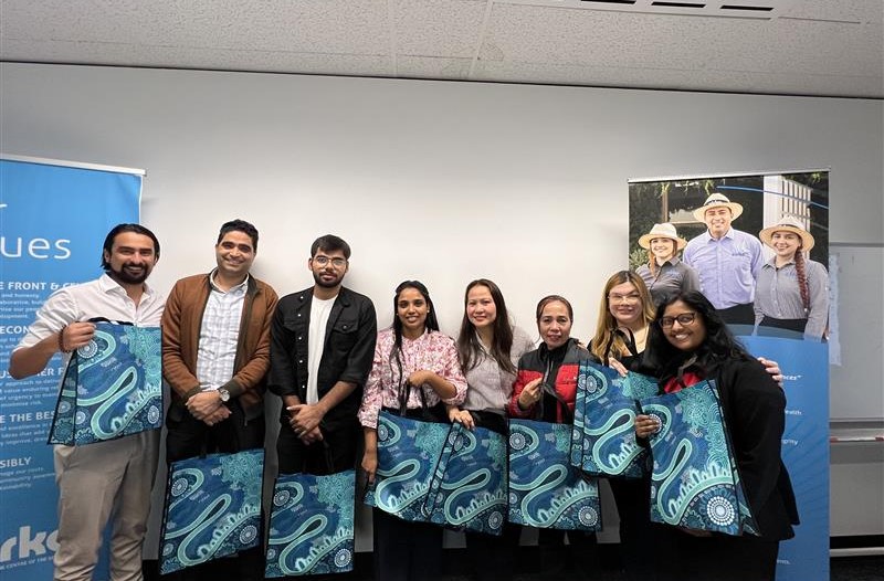 People from Cirka posing with their aboriginal art bags